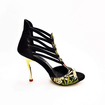 Sandalo donna Lilith Fleur Wish Dance Shop in pelle nera con tomaia oro, elastici neri e tacco slim oro.