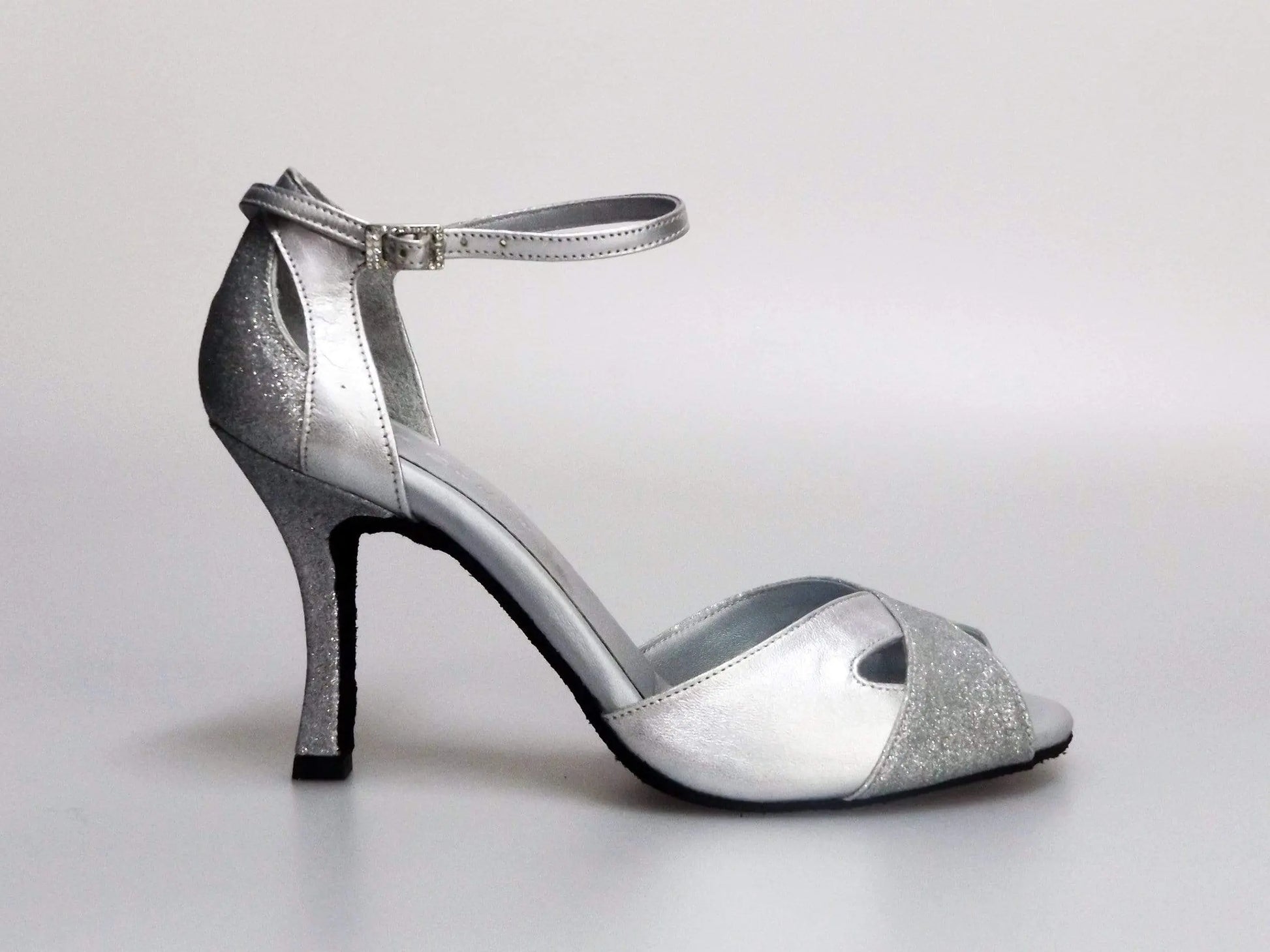 Scarpa da donna Wishdance Ely QA in pelle argento e glitter, cinturino alla caviglia e tacco rocchettino elegante.